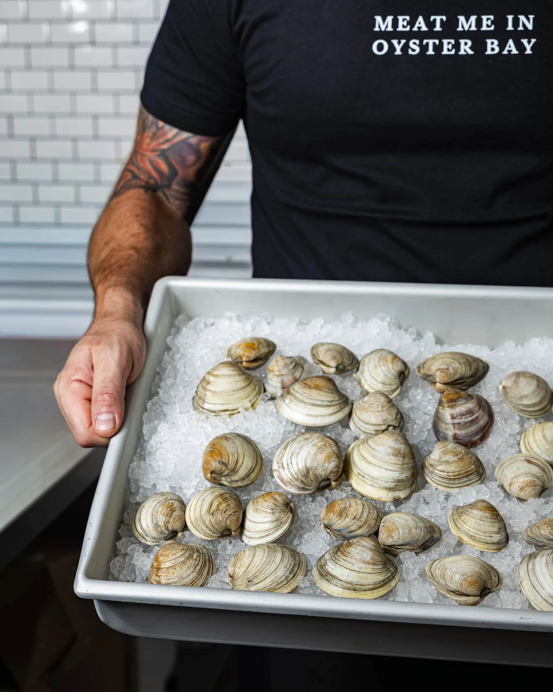 Angled tray of clams on crushed ice