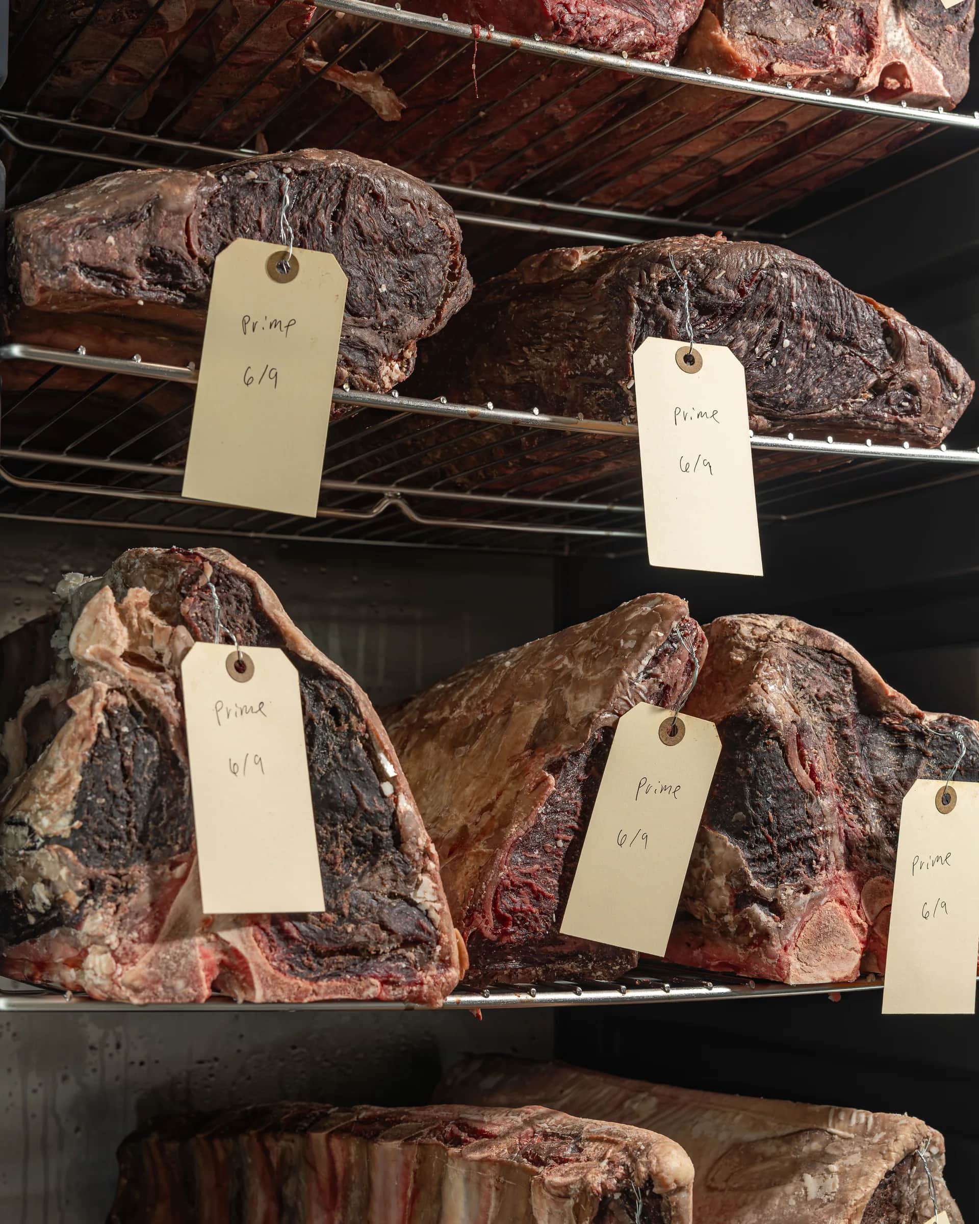 USDA Prime dry-aging shelves with tagged loins